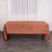 Rust-colored tablecloth draped over a table in a studio setting.
