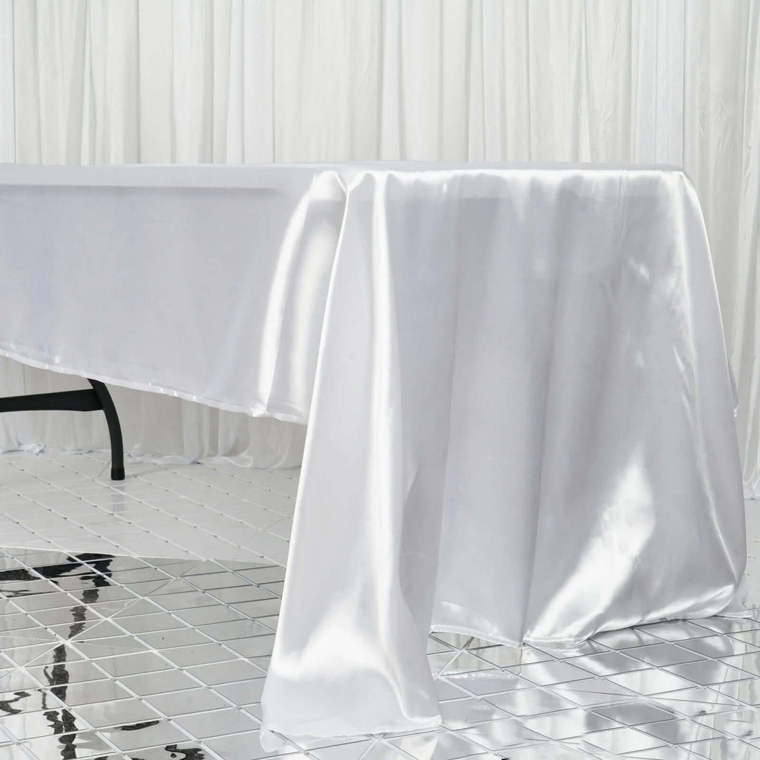 Shiny white tablecloth draped elegantly over a table