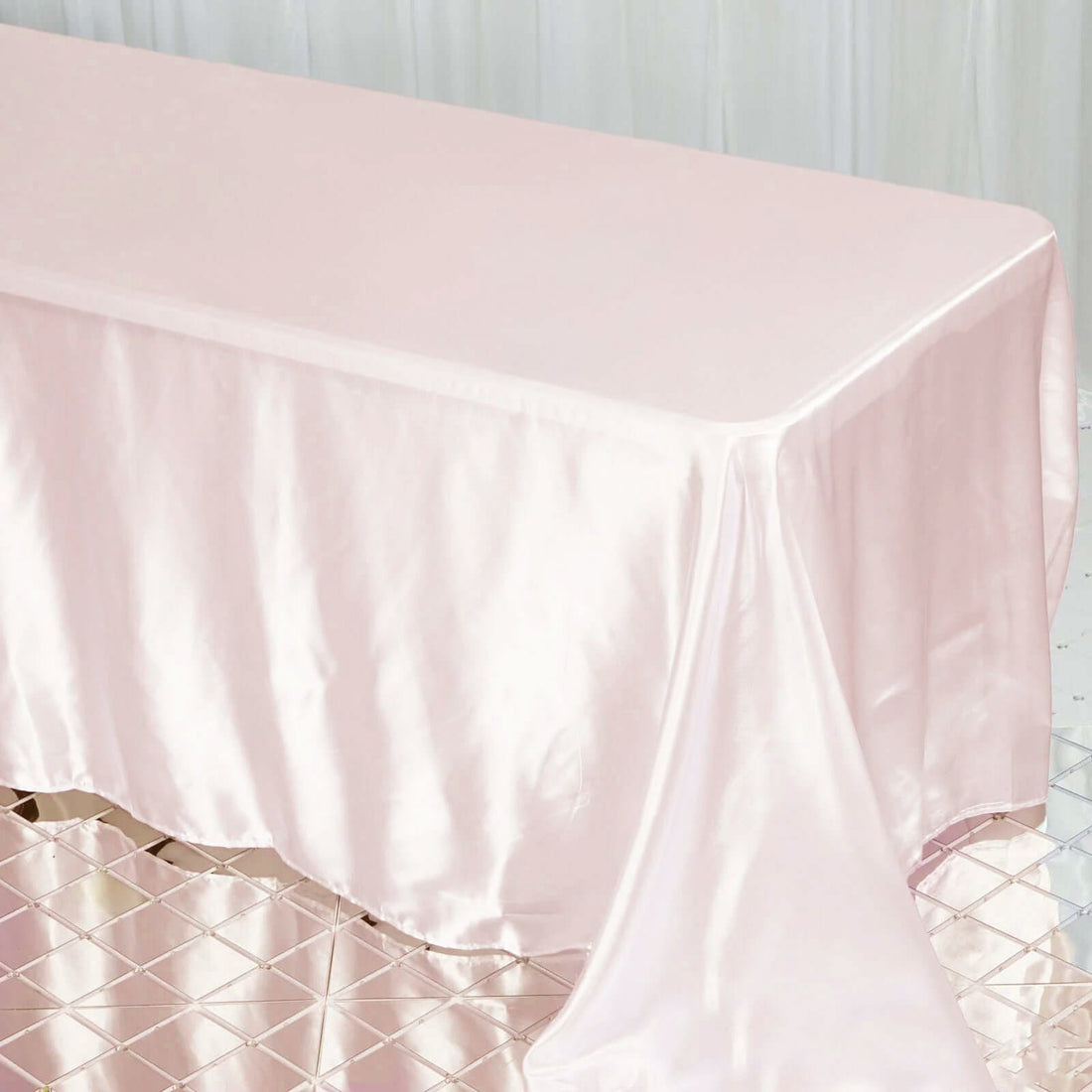 Pink satin tablecloth draped over a table for elegant events.