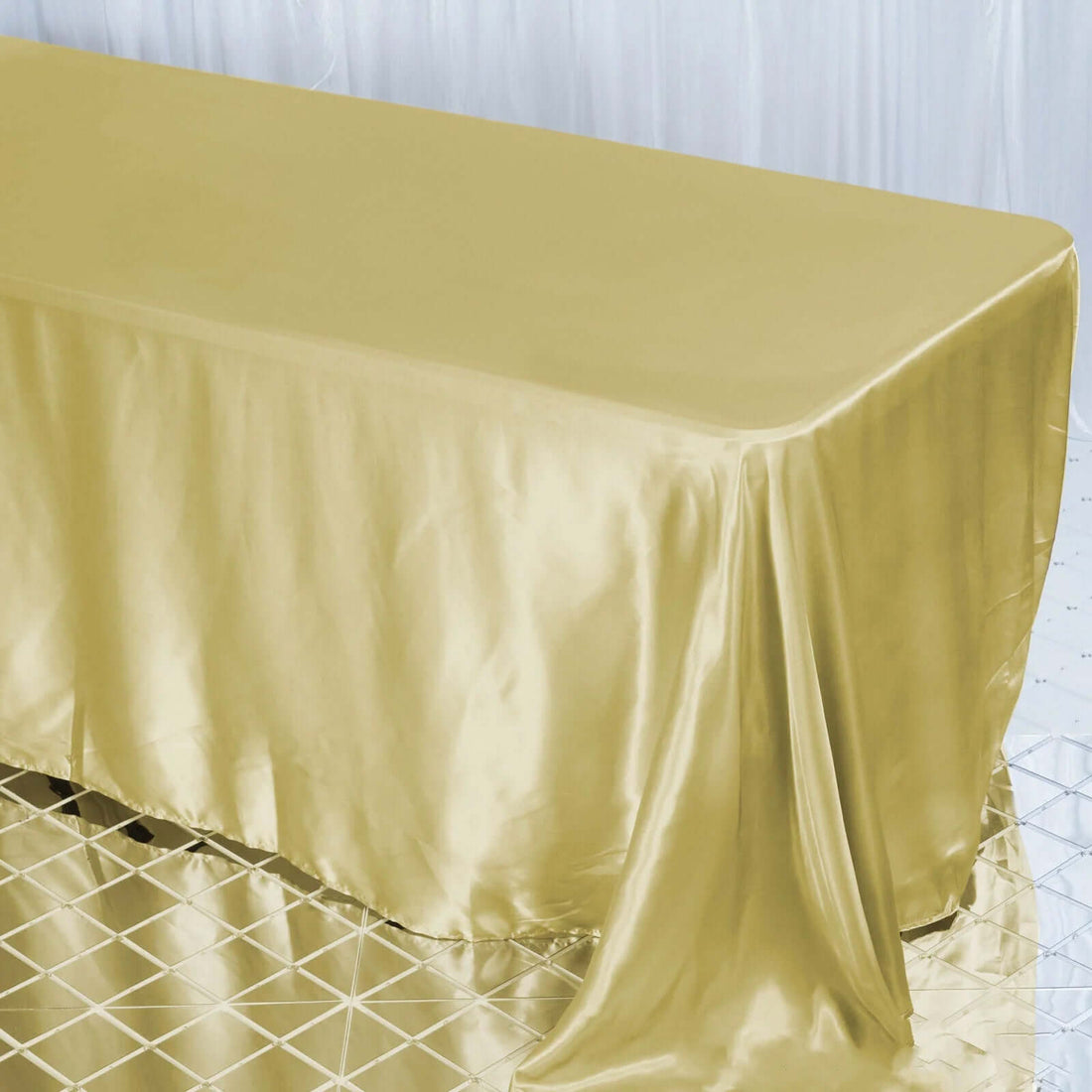 Gold satin tablecloth draped elegantly over a table.