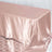 Rose gold satin tablecloth on a table.