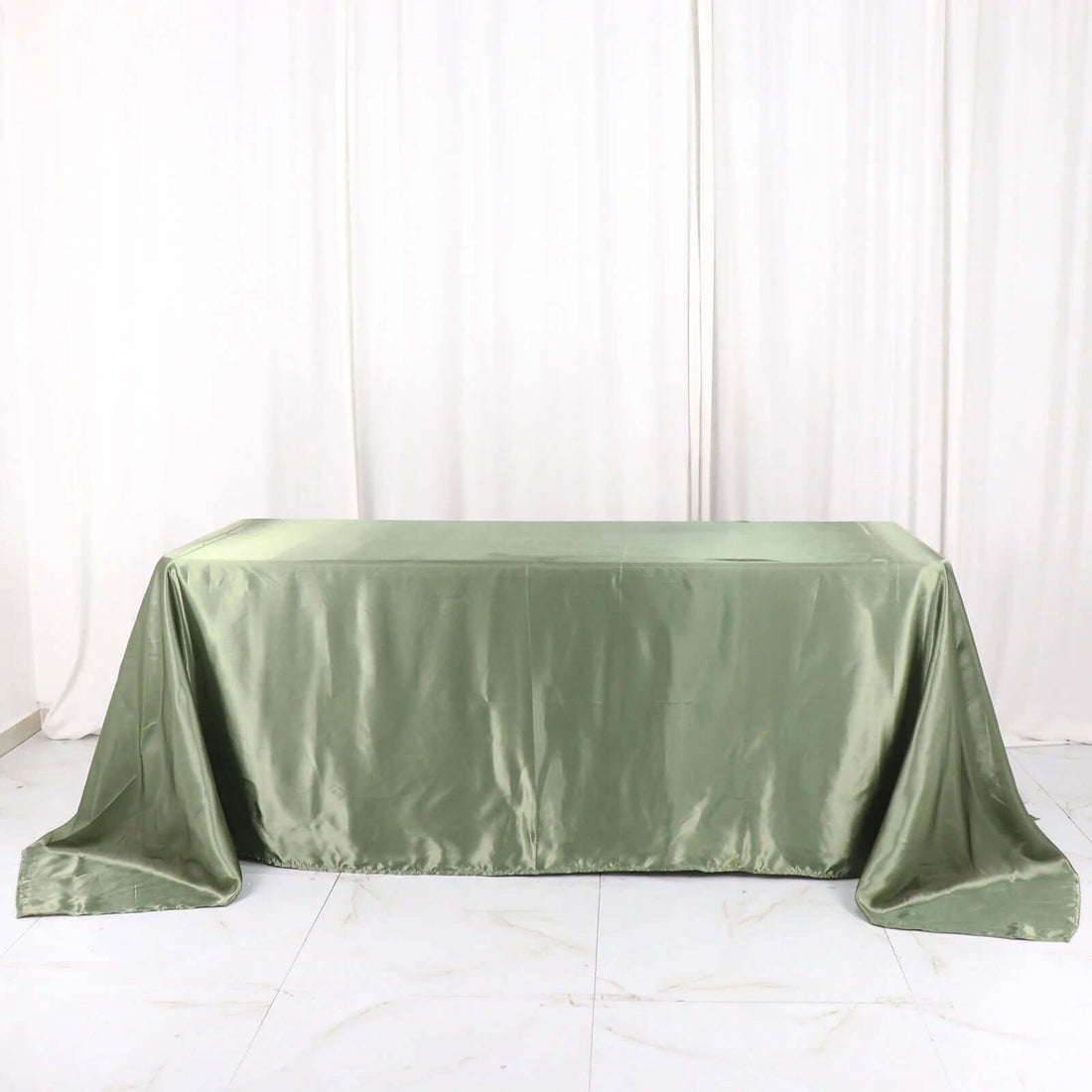 Green satin tablecloth draped elegantly over a table