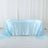 Light blue satin tablecloth draped over a table in a studio setting.