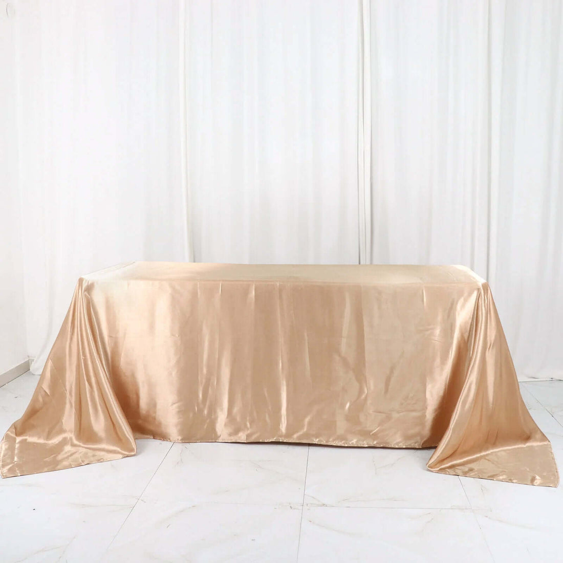 Gold satin tablecloth draped elegantly on a table