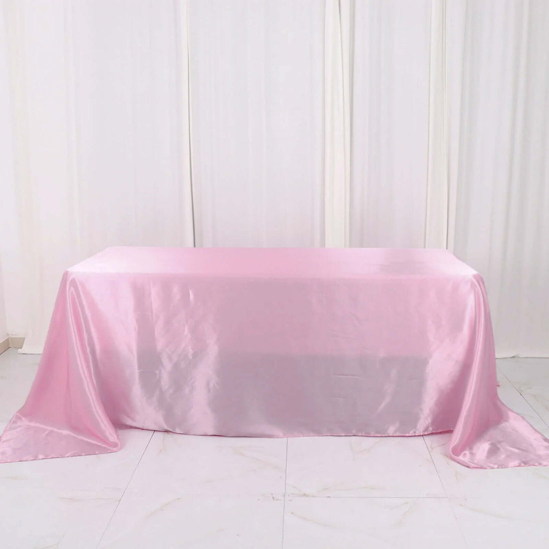 Pink satin tablecloth draped elegantly over a table.