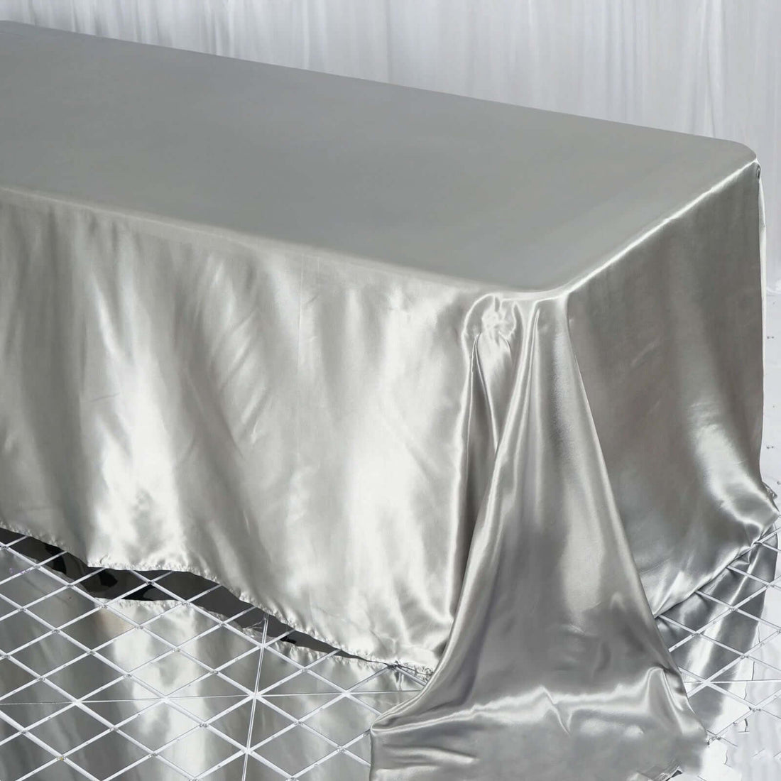 Silver satin tablecloth draped elegantly over a table.