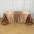 Brown satin tablecloth draped over a table on a wooden floor.