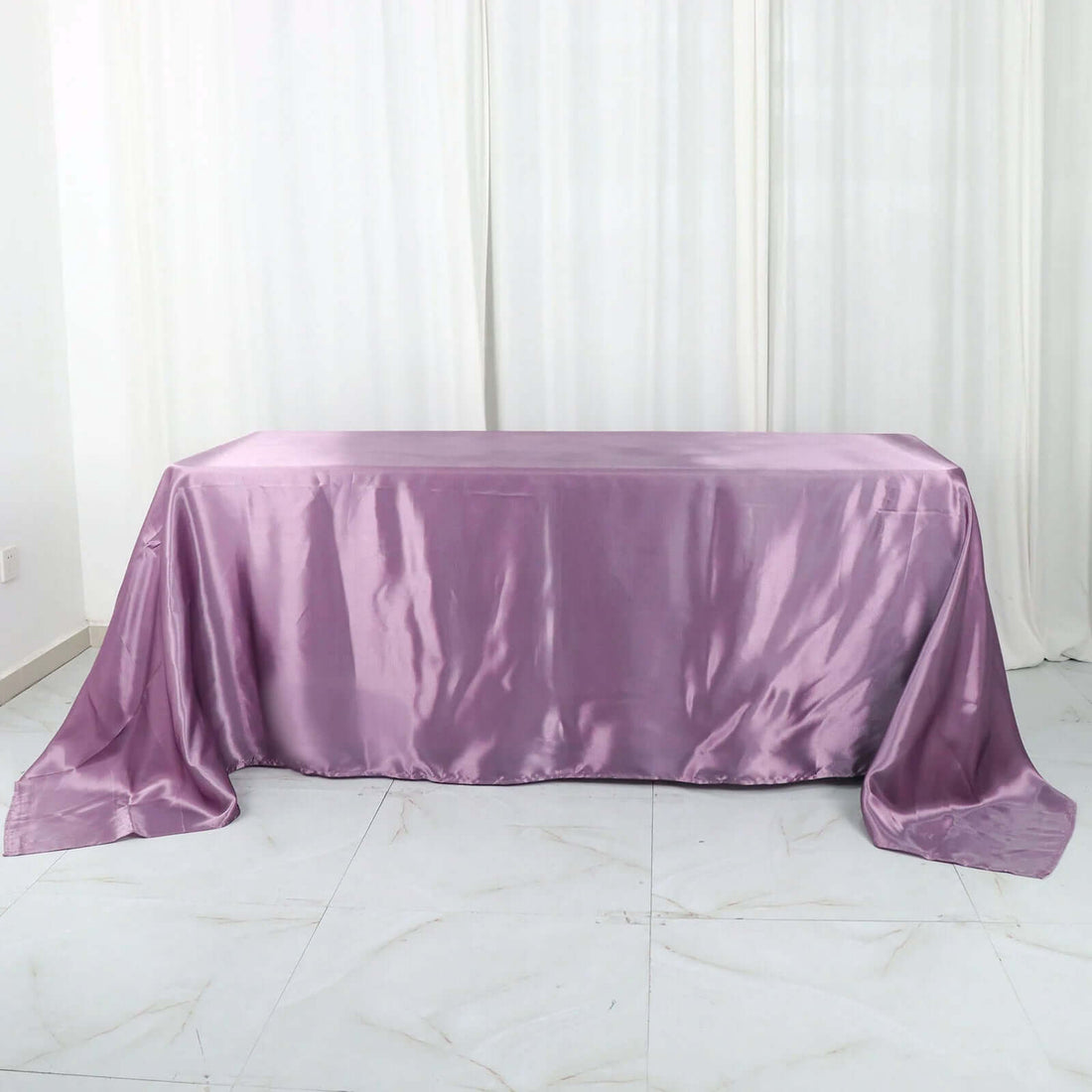 Purple satin tablecloth on a white backdrop