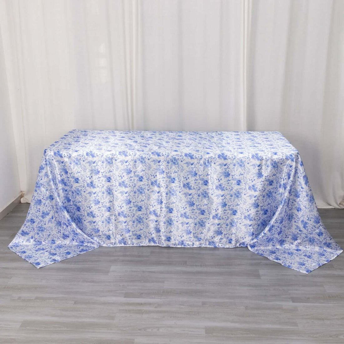 Floral blue tablecloth on a grey wooden floor