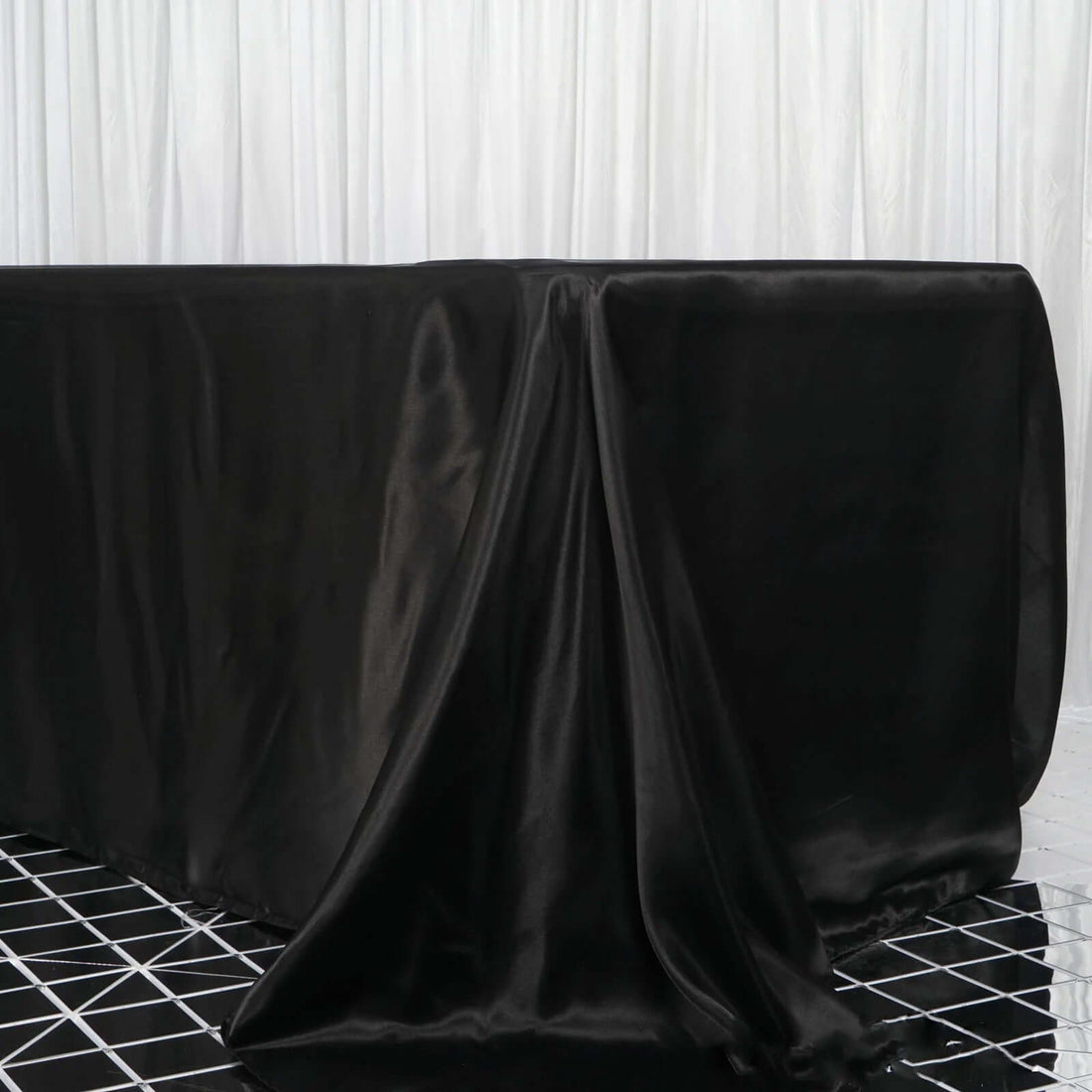 Black satin tablecloth draped elegantly over a table.