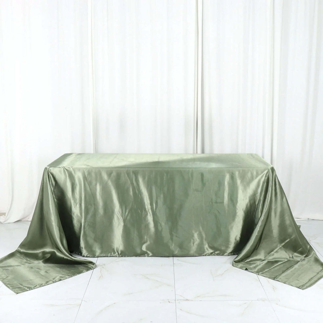 Green satin tablecloth draped elegantly over a table.