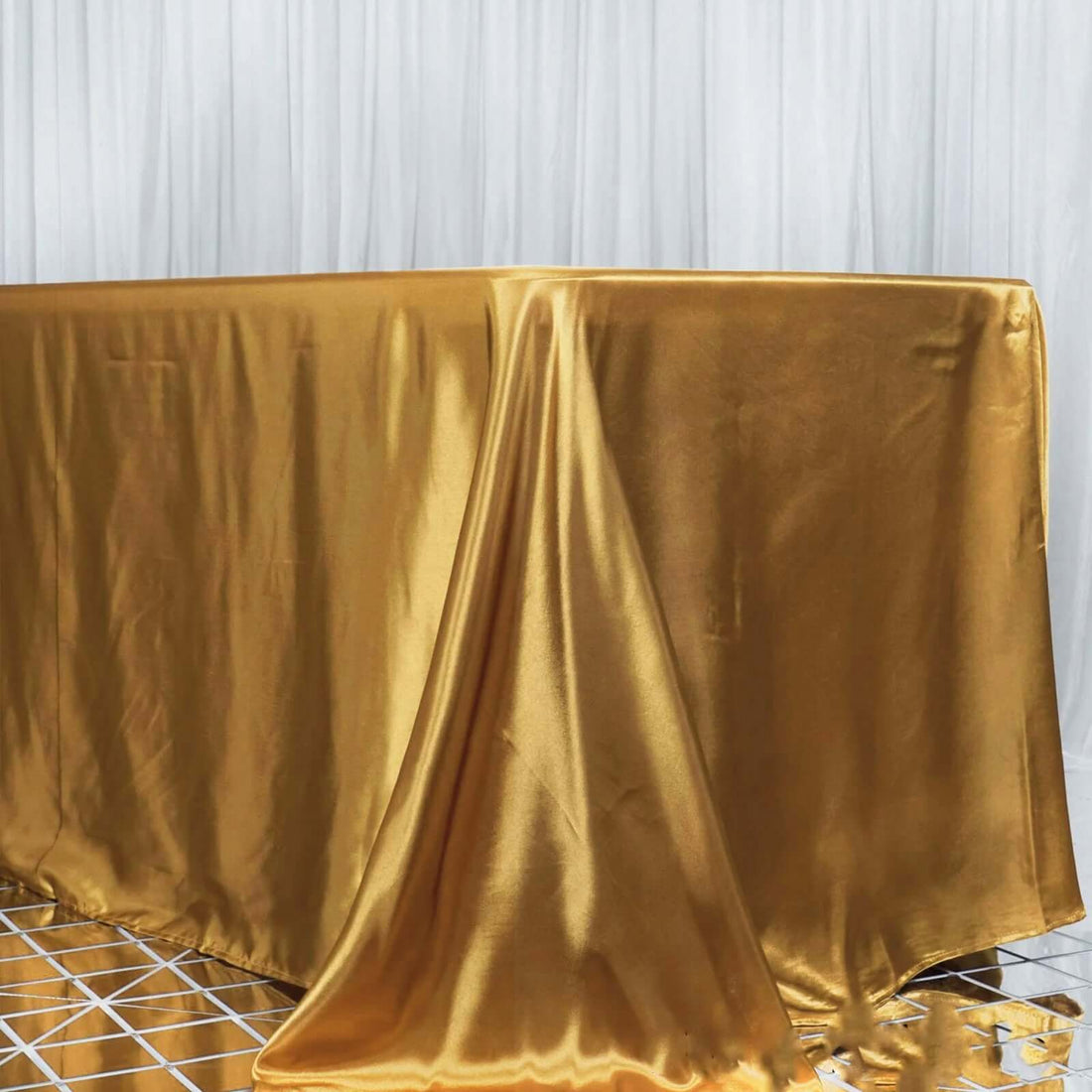 Gold satin tablecloth draped elegantly over a table.
