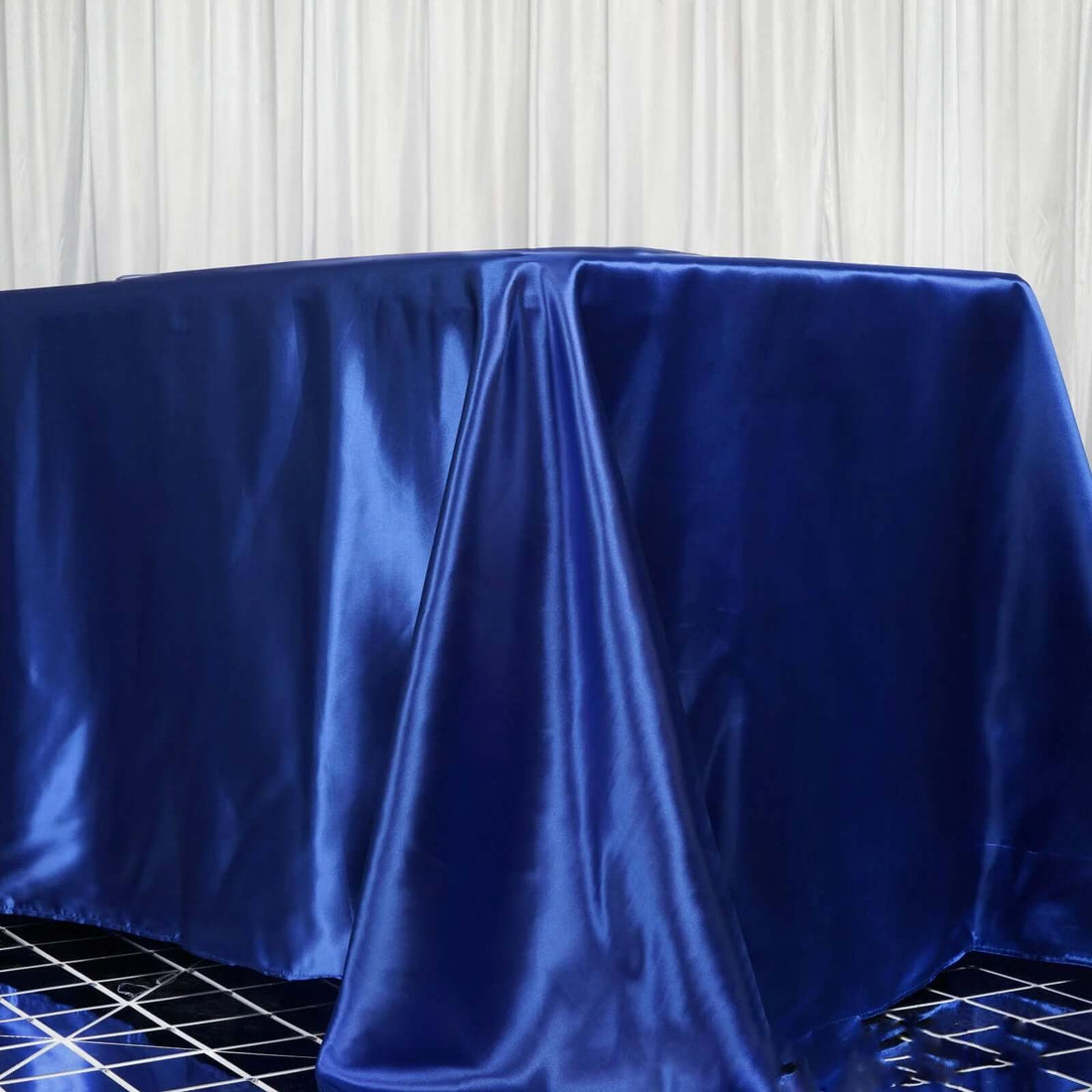 Blue satin tablecloth draped elegantly over a table.