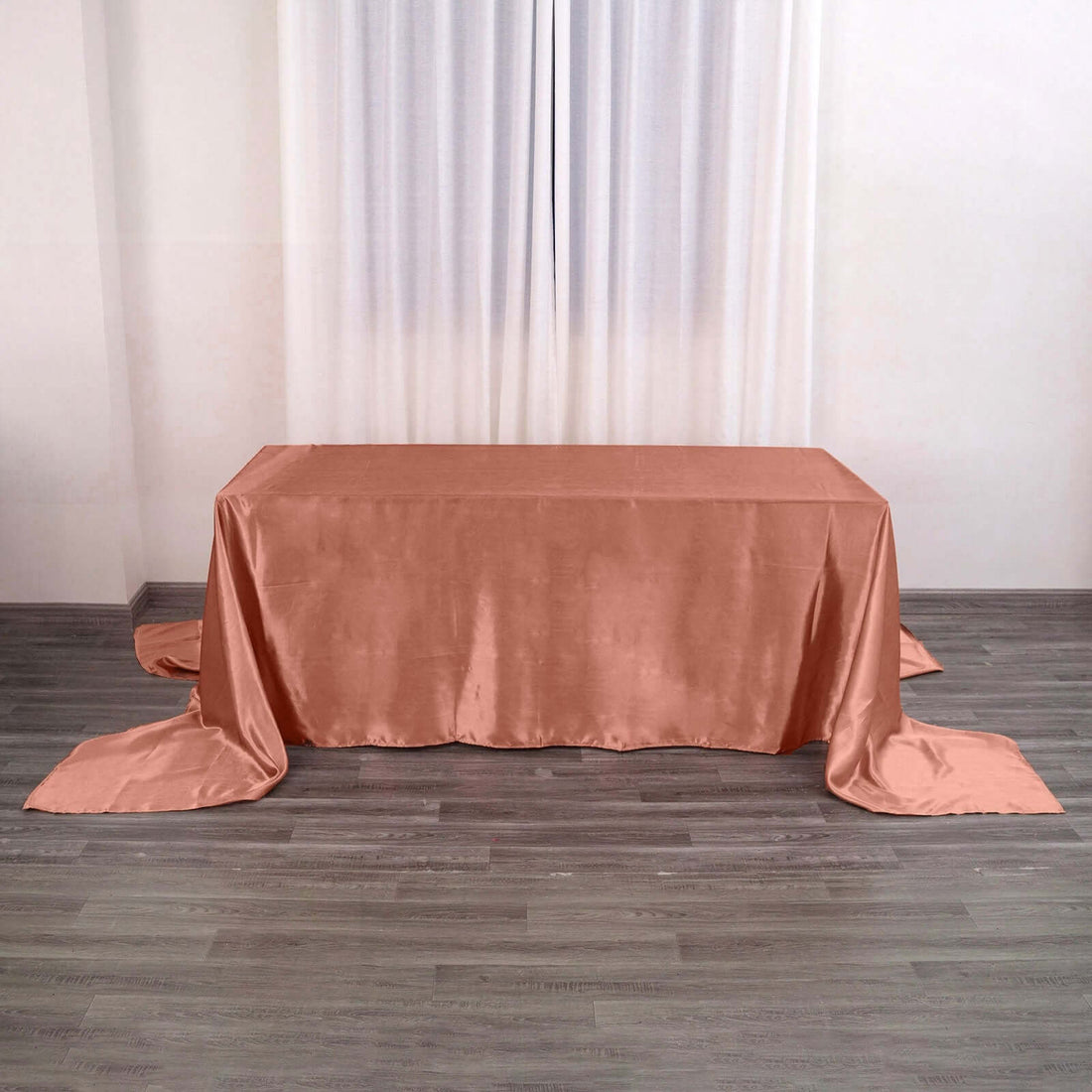 Peach satin tablecloth draped elegantly on a wooden table