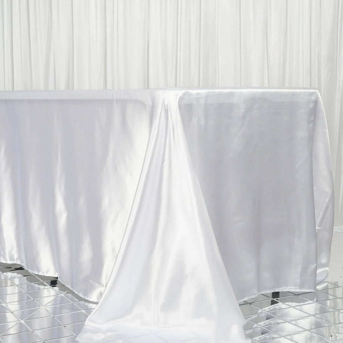 White satin tablecloth draping elegantly over a table.