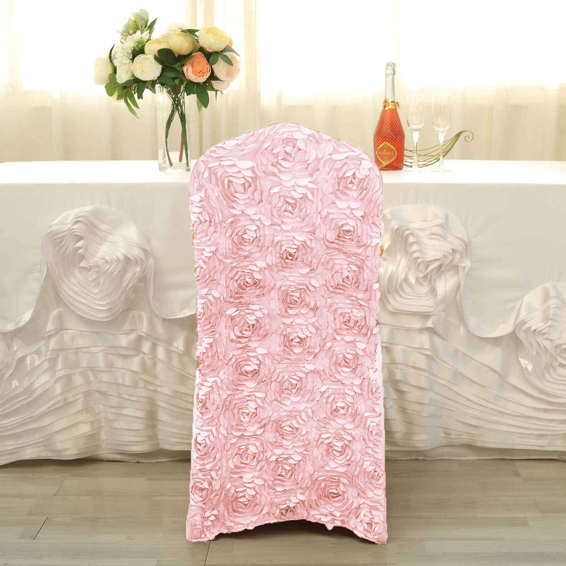 Pink floral chair cover for elegant events and decorations.