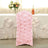 Pink floral chair cover for elegant events and decorations.