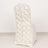 White chair with rose-patterned backrest on a plain backdrop.