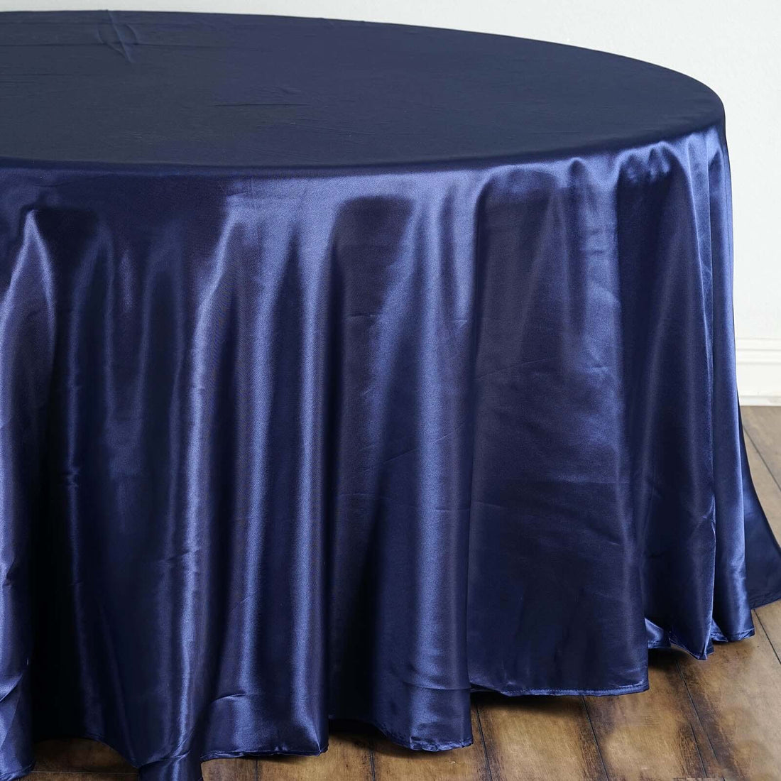 Navy satin tablecloth draped elegantly over a round table.