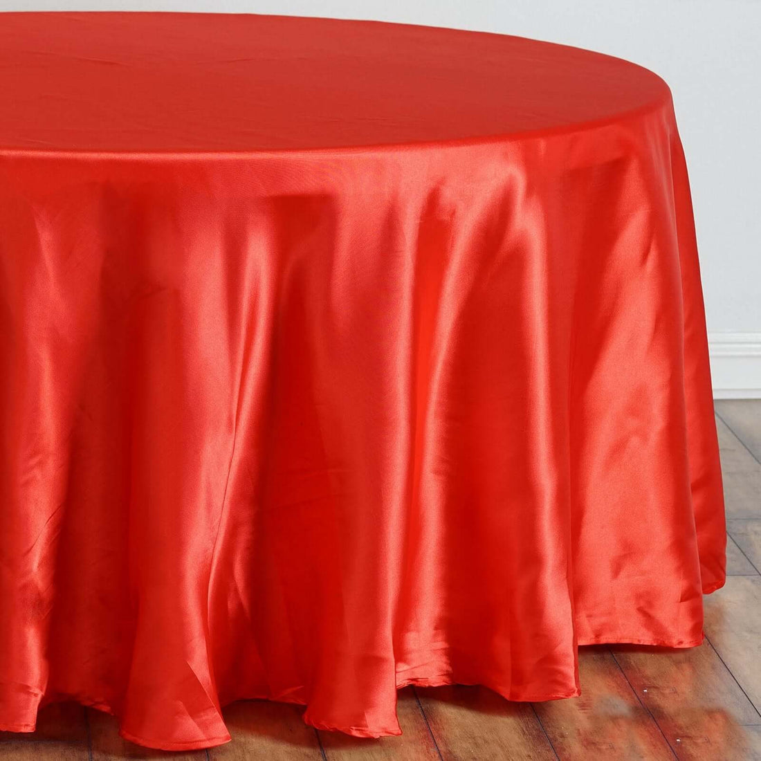 Red round tablecloth draping elegantly over a table.