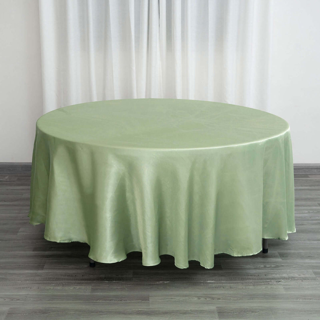 Round green tablecloth draped elegantly over a table.