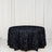 Black rose-patterned tablecloth on a round table against a white backdrop.