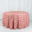 Pink rose-patterned round tablecloth on a plain white backdrop.
