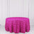 Pink rose-patterned tablecloth on a round table against a white backdrop.