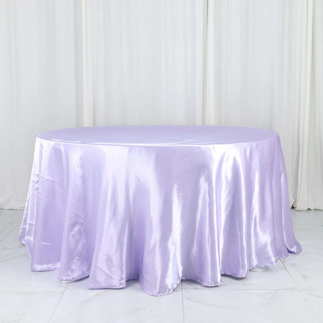 Lavender satin tablecloth draped over a round table