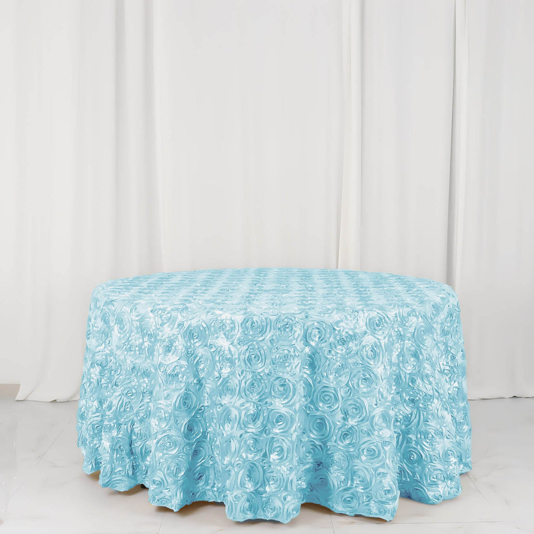 Light blue rose-patterned tablecloth on a round table