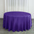 Purple round tablecloth on a wooden floor with curtains in the background.