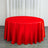 Red tablecloth draped over a round table in a bright setting.