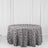 Gray floral tablecloth draped over a round table against a plain backdrop