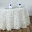 White rose tablecloth with elegant napkin and glassware setup.