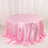 Round pink satin tablecloth with elegant draping.
