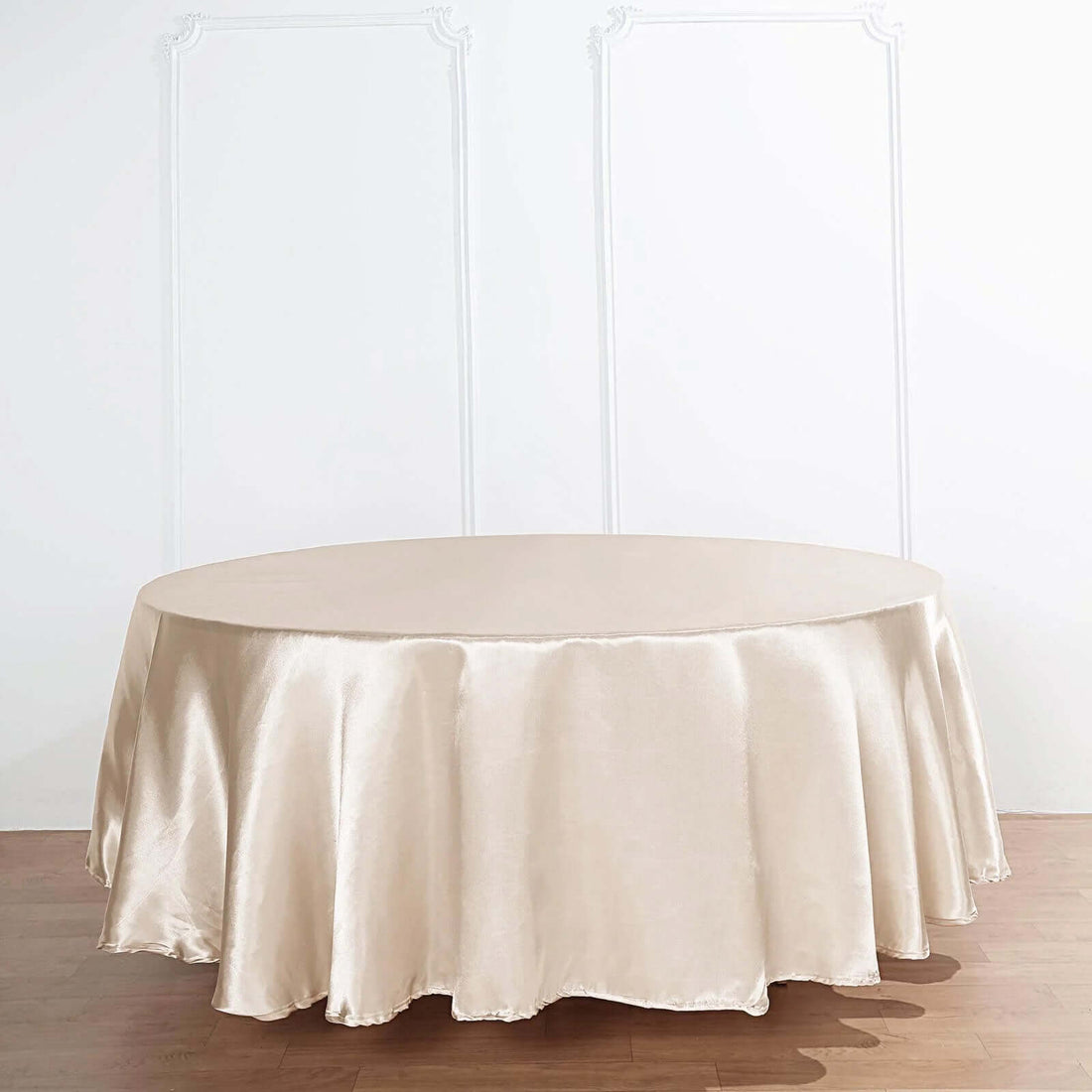 Beige round tablecloth on a wooden table.