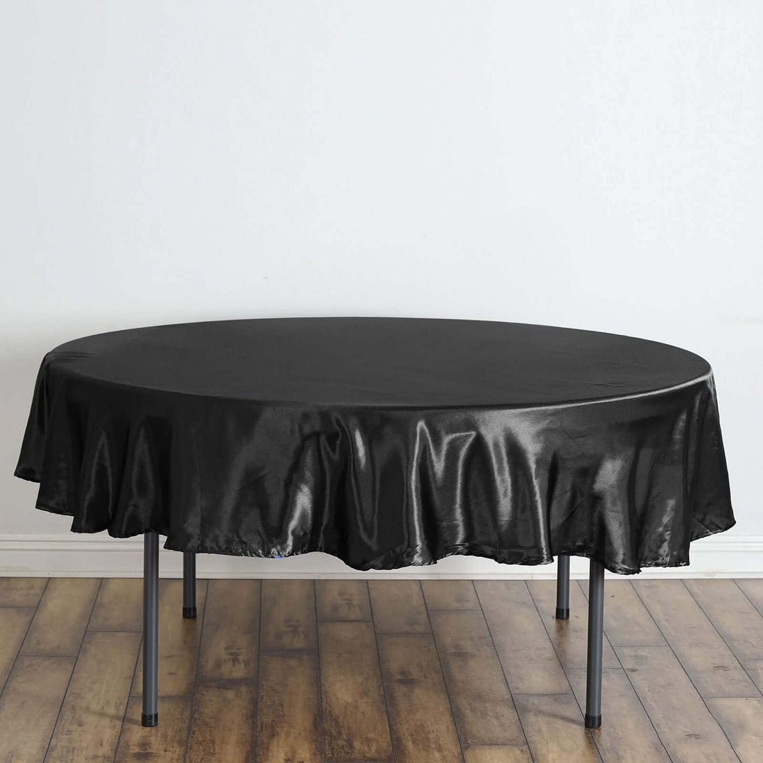 Round black tablecloth draped elegantly over a table.