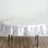 Round white satin tablecloth on a wooden table.