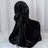 Black satin chair cover draped elegantly on a chair.