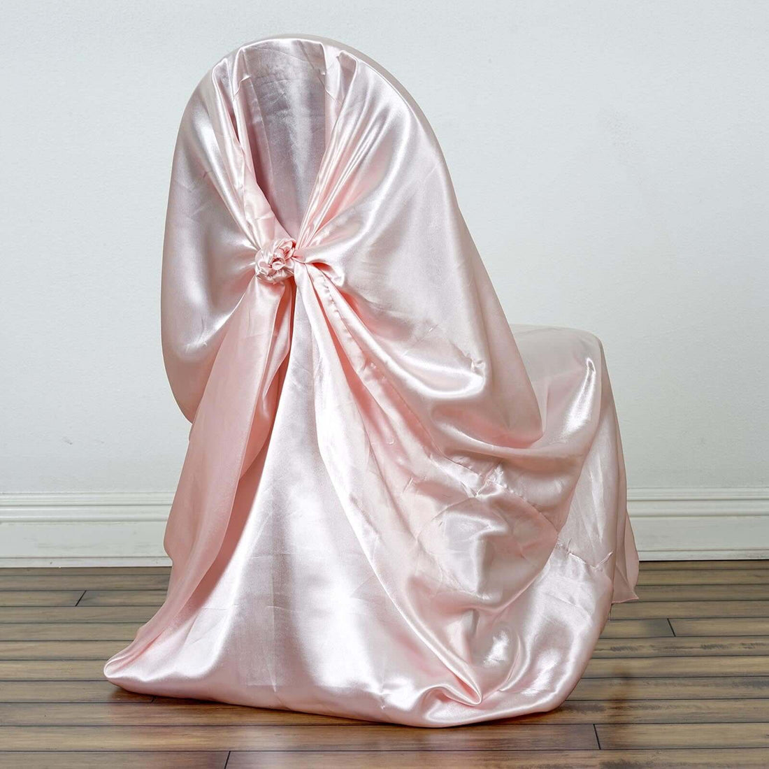 Pink satin chair cover draped elegantly over a chair.