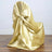 Gold satin chair cover with elegant bow detail.