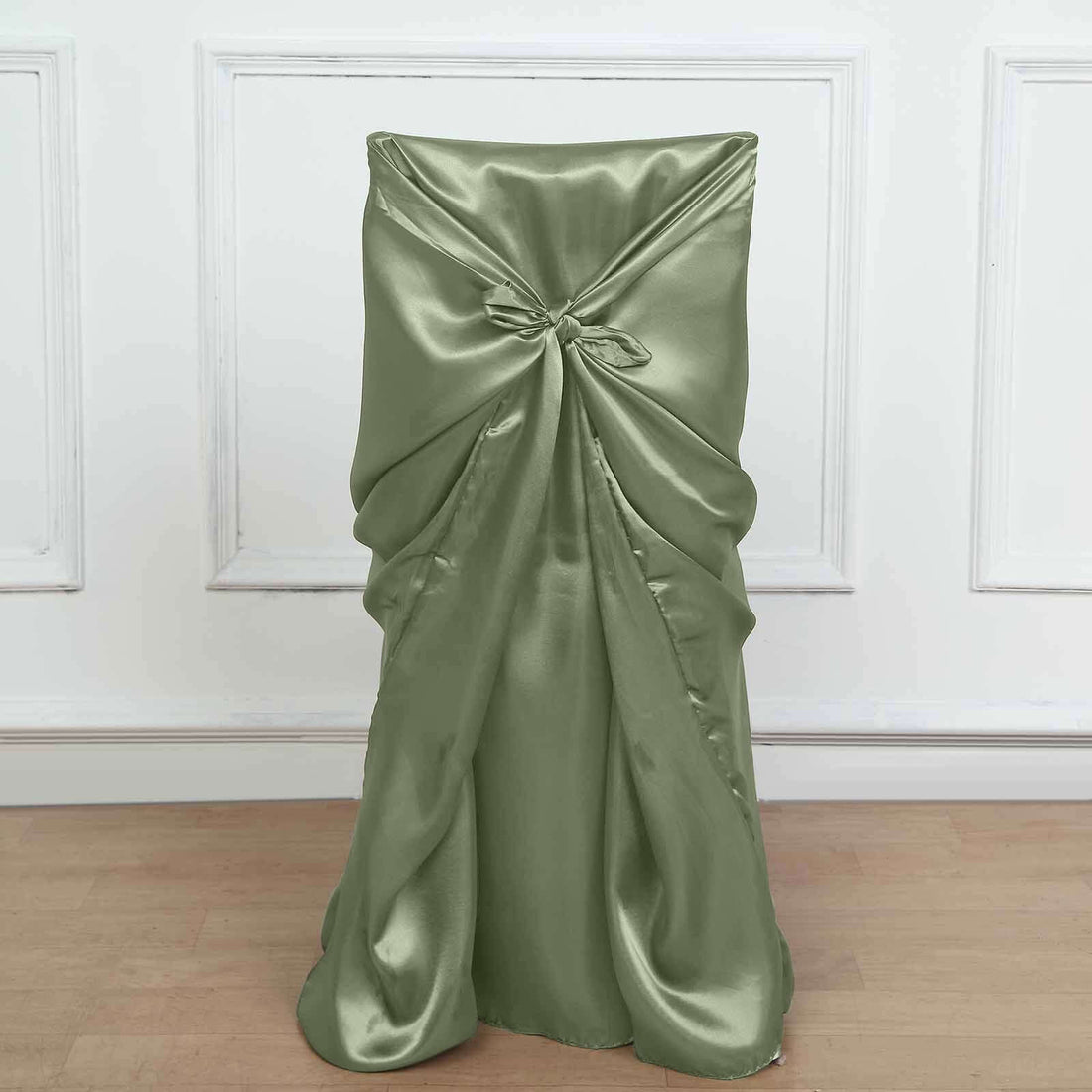 Green satin chair cover with tied bow detail on a plain background.