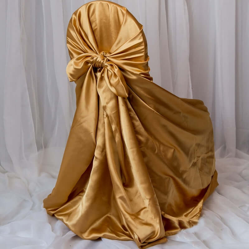 Gold satin chair cover with bow detail.