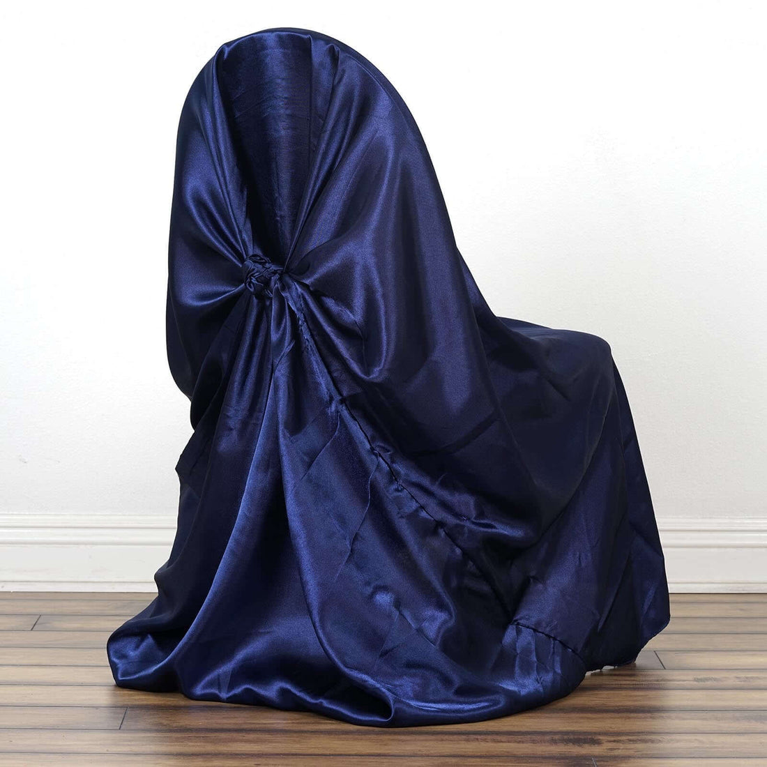 Navy blue satin chair cover draped elegantly over a chair.