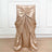 Gold satin chair cover with elegant draping and bow detail.
