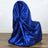 Blue satin chair cover draped elegantly over a chair.