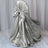 Silver satin chair cover with bow detail, elegantly draped.