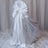 Elegant white satin chair cover draped with a bow