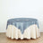 Round table with blue satin tablecloth and white skirt, set for dining.