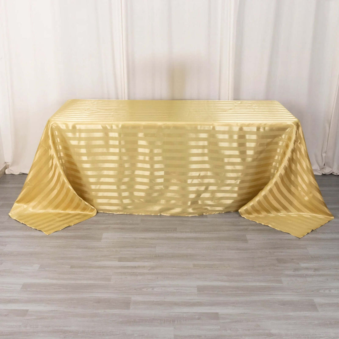 Gold striped tablecloth draped elegantly over a table.